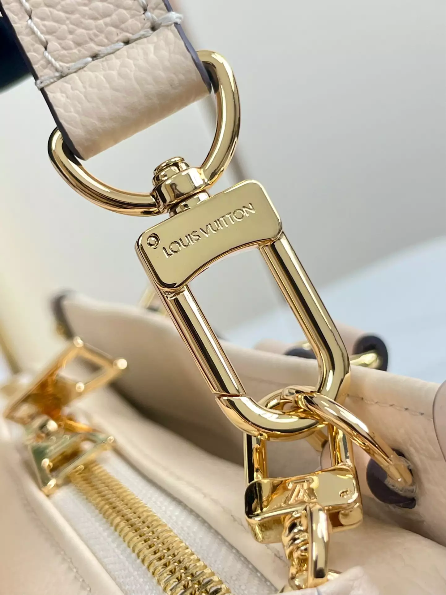 OnTheGo East West Monogram Empreinte Creme Leather