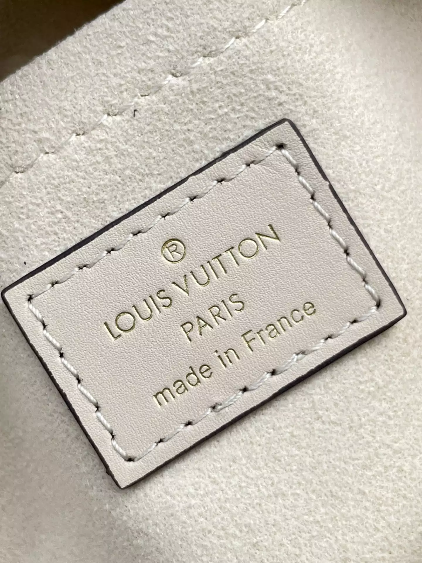 OnTheGo East West Monogram Empreinte Creme Leather