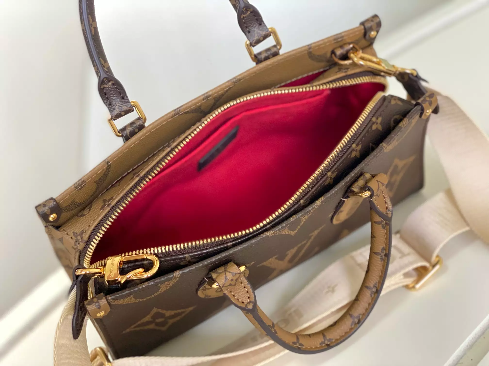 Onthego East West Monogram Reverse Brown Latte