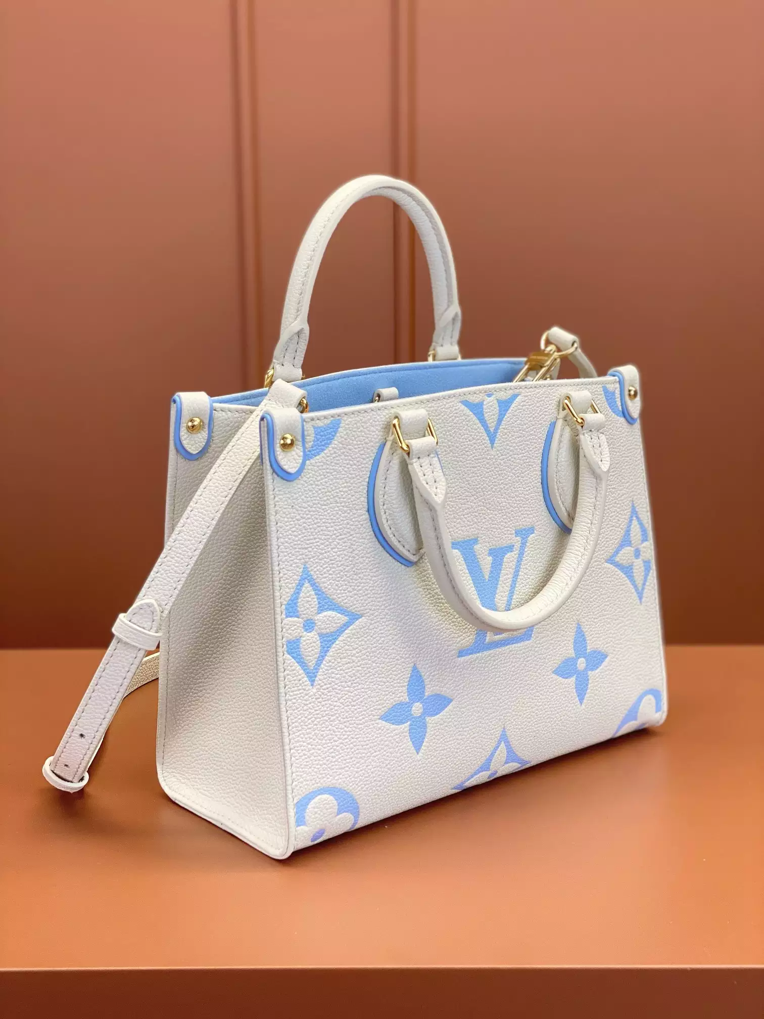 OnTheGo PM Bicolor Monogram Empreinte Latte/Candy Blue Leather