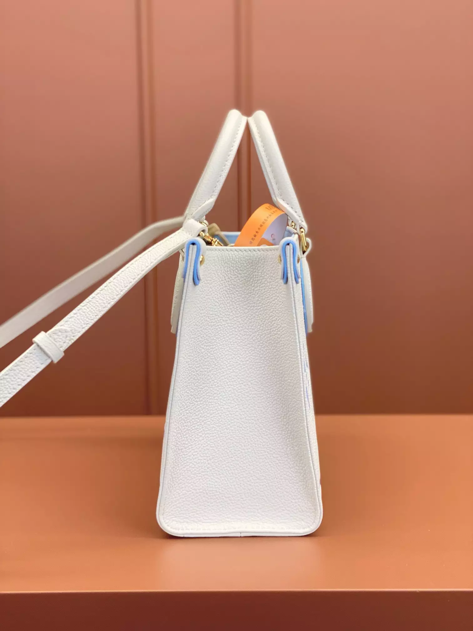 OnTheGo PM Bicolor Monogram Empreinte Latte/Candy Blue Leather